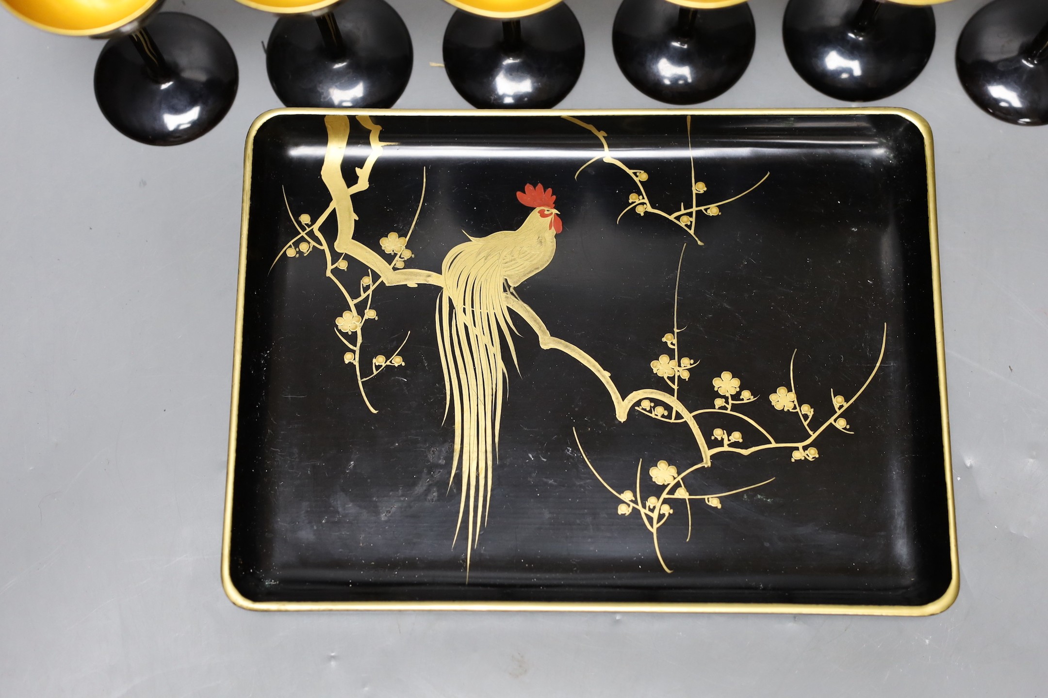 A set of six Japanese lacquer cocktail or liqueur cups and a similar tray